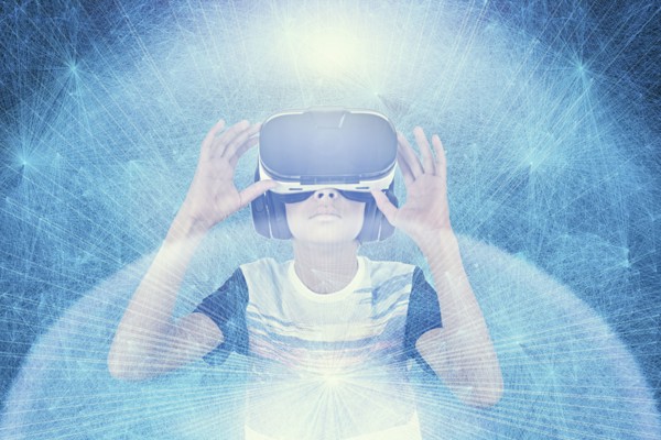 Mixed Race boy wearing VR goggles in cyberspace