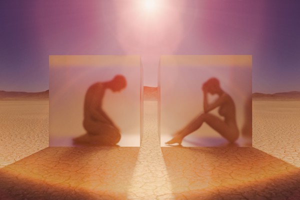 Separated couple in suspended animation in desert