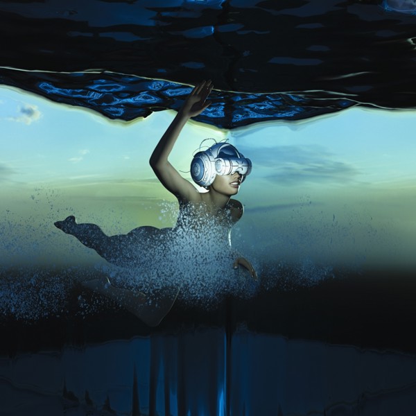 Woman swimming underwater wearing virtual reality helmet