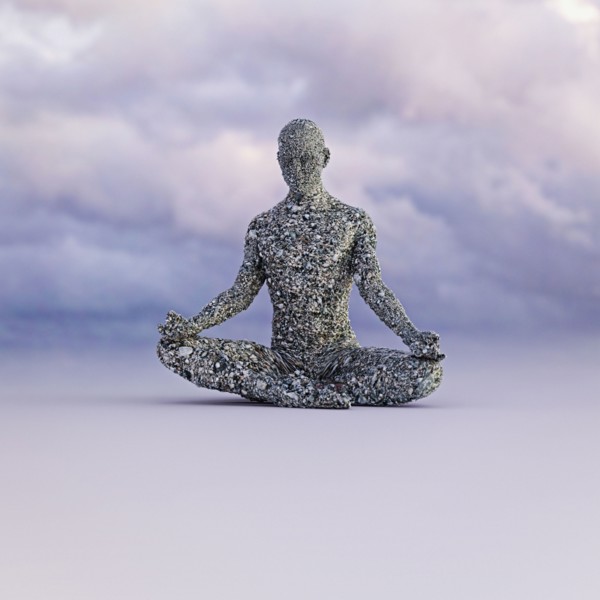 Stone man meditating under clouds