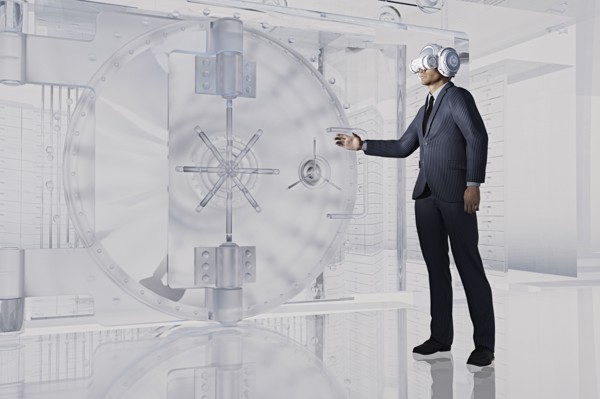Businessman near vault wearing virtual reality goggles