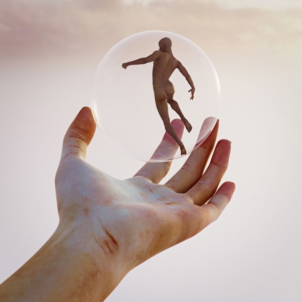 Hand holding naked man in sphere