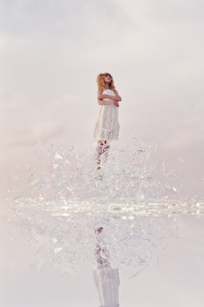 Woman hovering in shards of glass