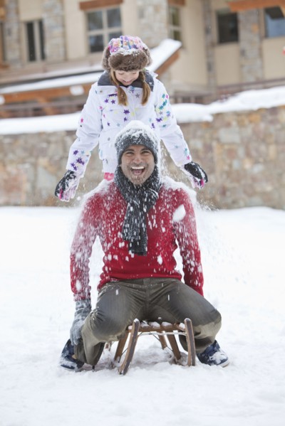 Father and daughter playing in snow