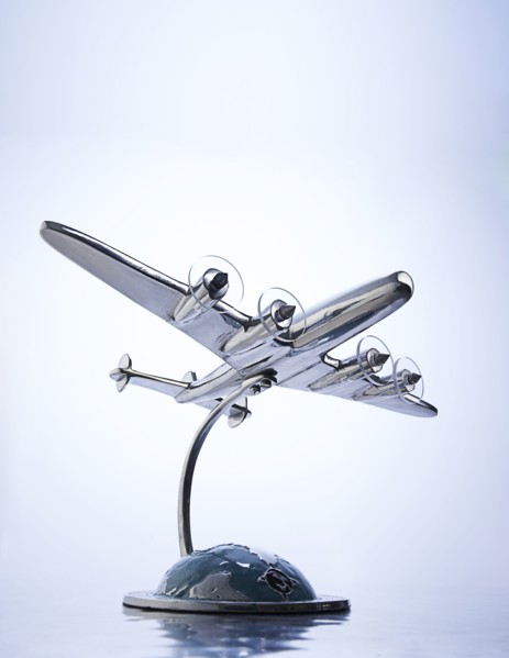Model of airplane flying over globe