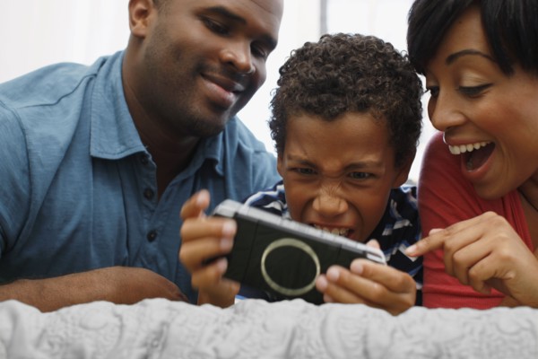 Parents watching son play video game