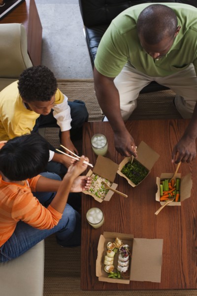 Family eating take-out Asian food