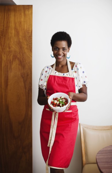 African American woman holding a bowl of salad
