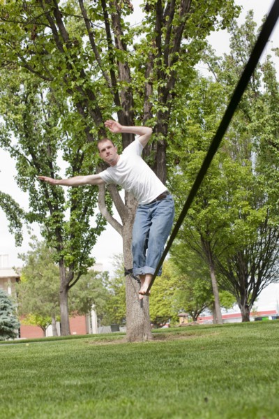 Caucasian man balancing on rope in park