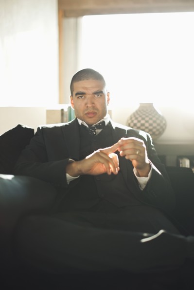 Serious mixed race businessman sitting in chair