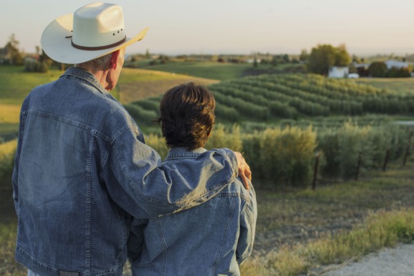 Hispanic farmers standing in vineyard