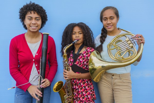 Pacific Islander girls holding musical instruments