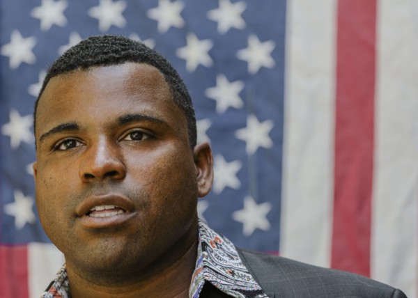 Close up of Black man in front of American flag