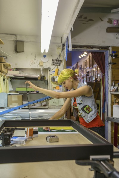 Caucasian artist working in screen print workshop