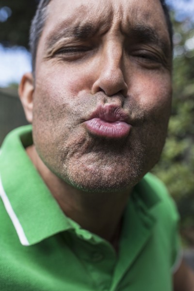 Mixed race man puckering