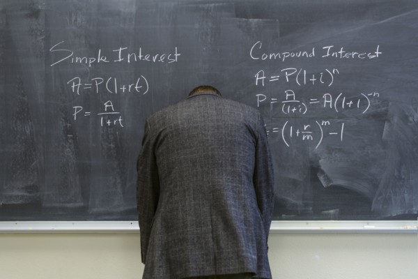 Caucasian teacher frustrated at chalkboard