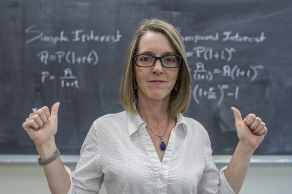 Caucasian teacher cheering at chalkboard
