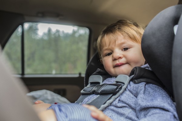 Mixed race girl sitting in car seat