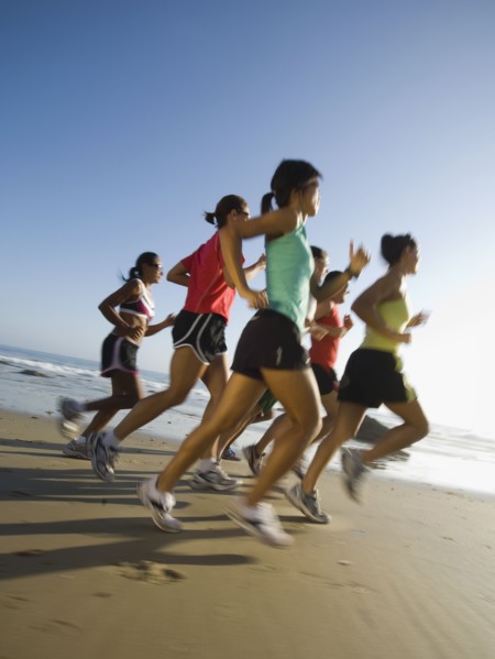 Multi-ethnic runners racing at beach