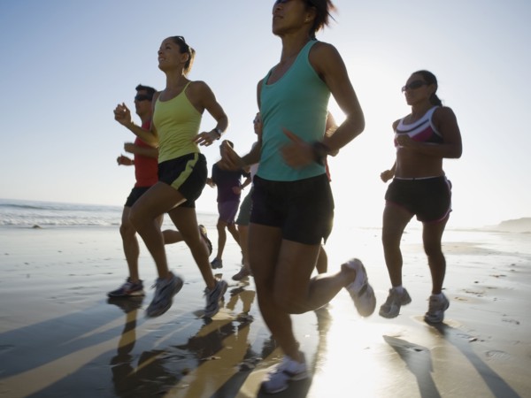 Multi-ethnic runners racing at beach