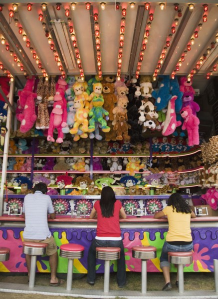 Multi-ethnic teenaged friends playing carnival game