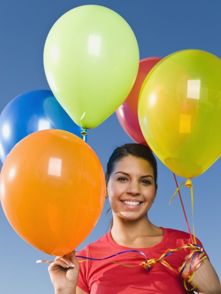 Native American holding balloons