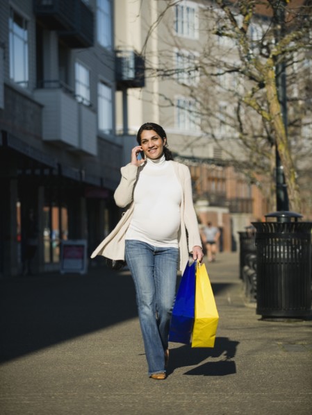 Pregnant Middle Eastern woman talking on cell phone