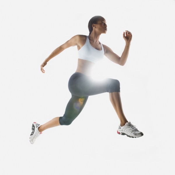 Mixed race woman jumping in mid-air