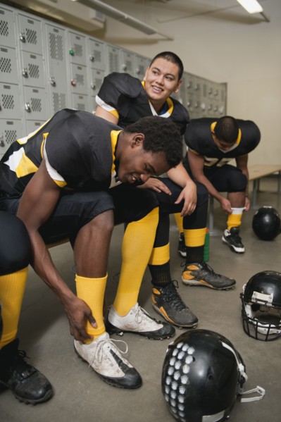 Football players dressing in locker room