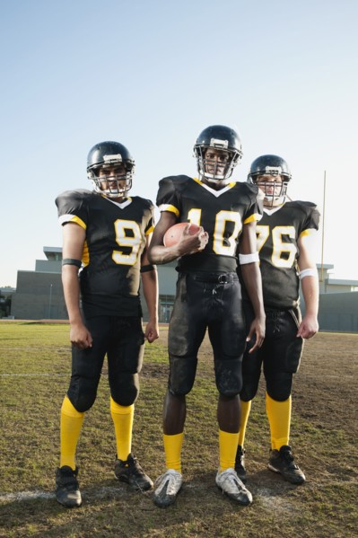 Football players standing on football field