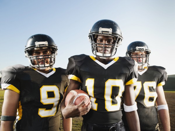 Football players standing on football field