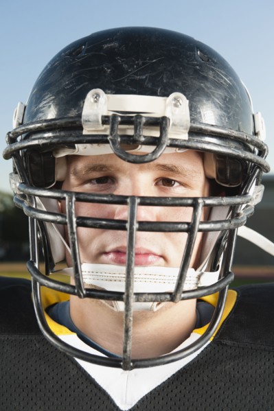 Serious Caucasian football player in helmet