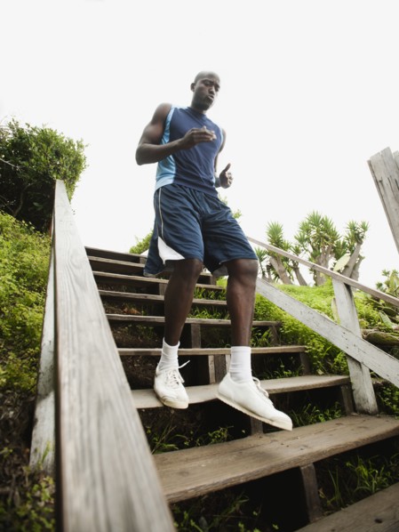 Black man running down stairs for exercise