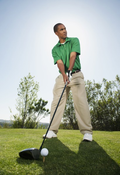 Black golfer preparing to swing golf club