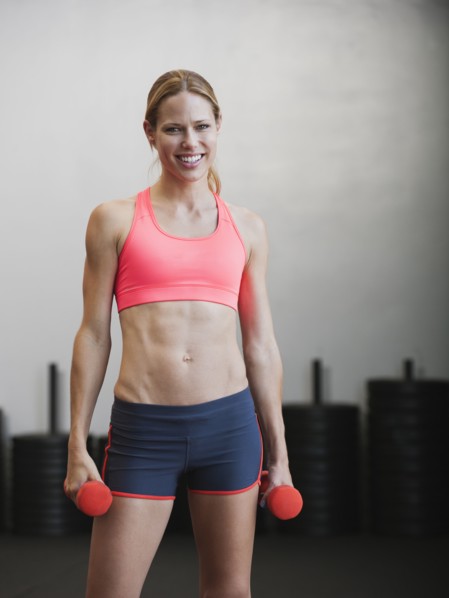 Caucasian woman using dumbbells