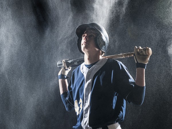 Caucasian baseball player standing in rain