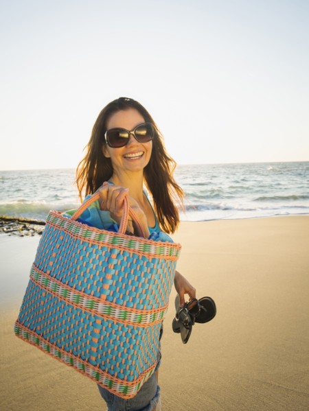 Mixed race woman walking on beach