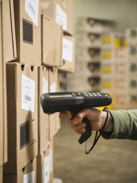 Hispanic worker scanning boxes in walk-in freezer