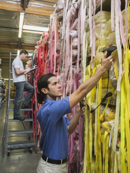 Workers examining fabric in textile factory