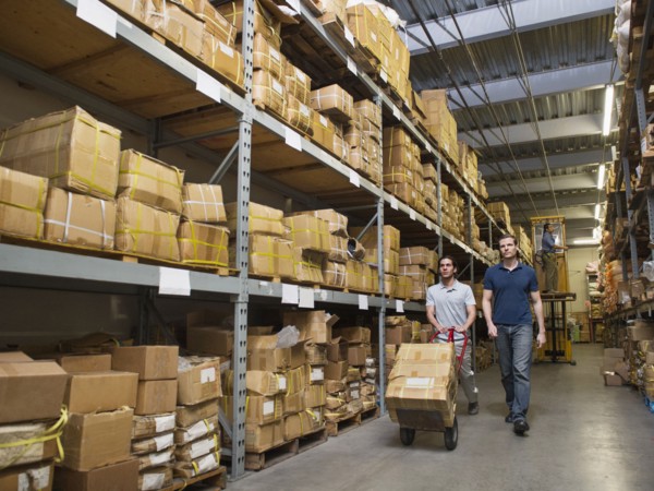 Workers carting boxes in textile factory