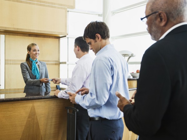 Business people in line at airport front desk