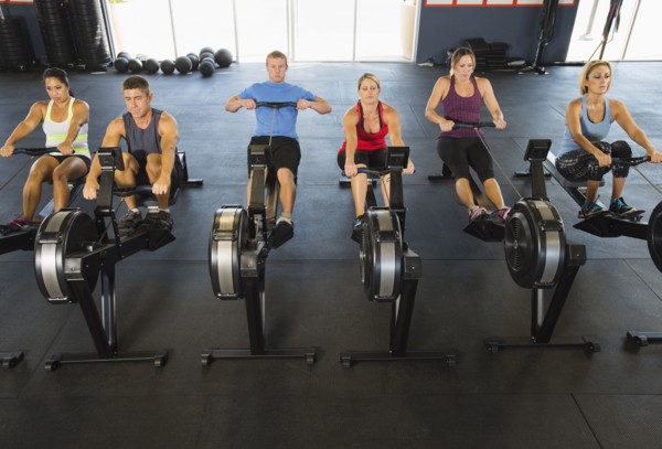 People using rowing machines in gym
