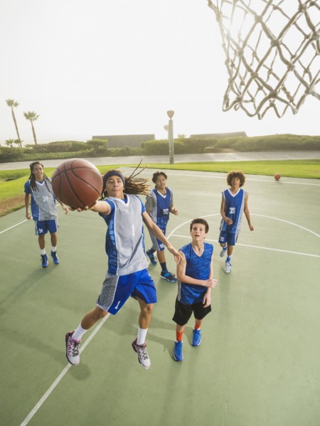 Basketball teams playing on court