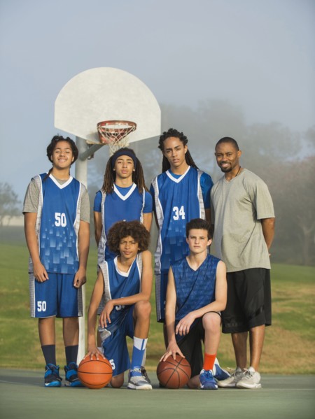 Basketball team posing on court