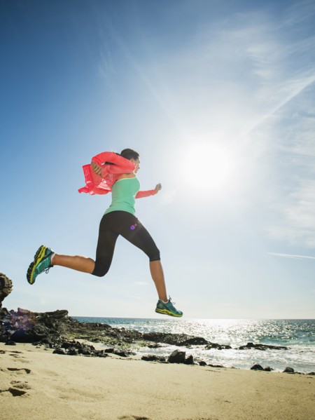 Caucasian woman running on beach