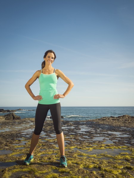 Caucasian runner smiling on beach
