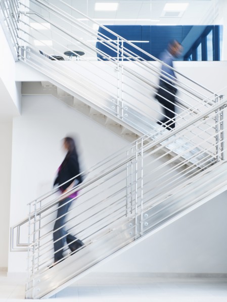 Blurred view of business people climbing office staircase