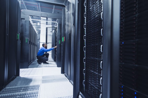 Black businessman working in server room