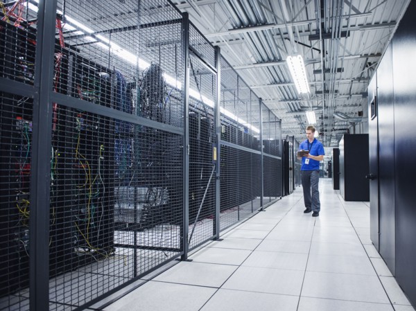 Caucasian technician using digital tablet in server room