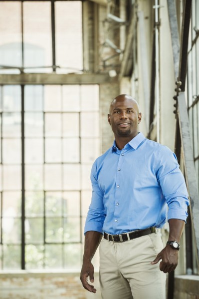 Black businessman smiling in warehouse